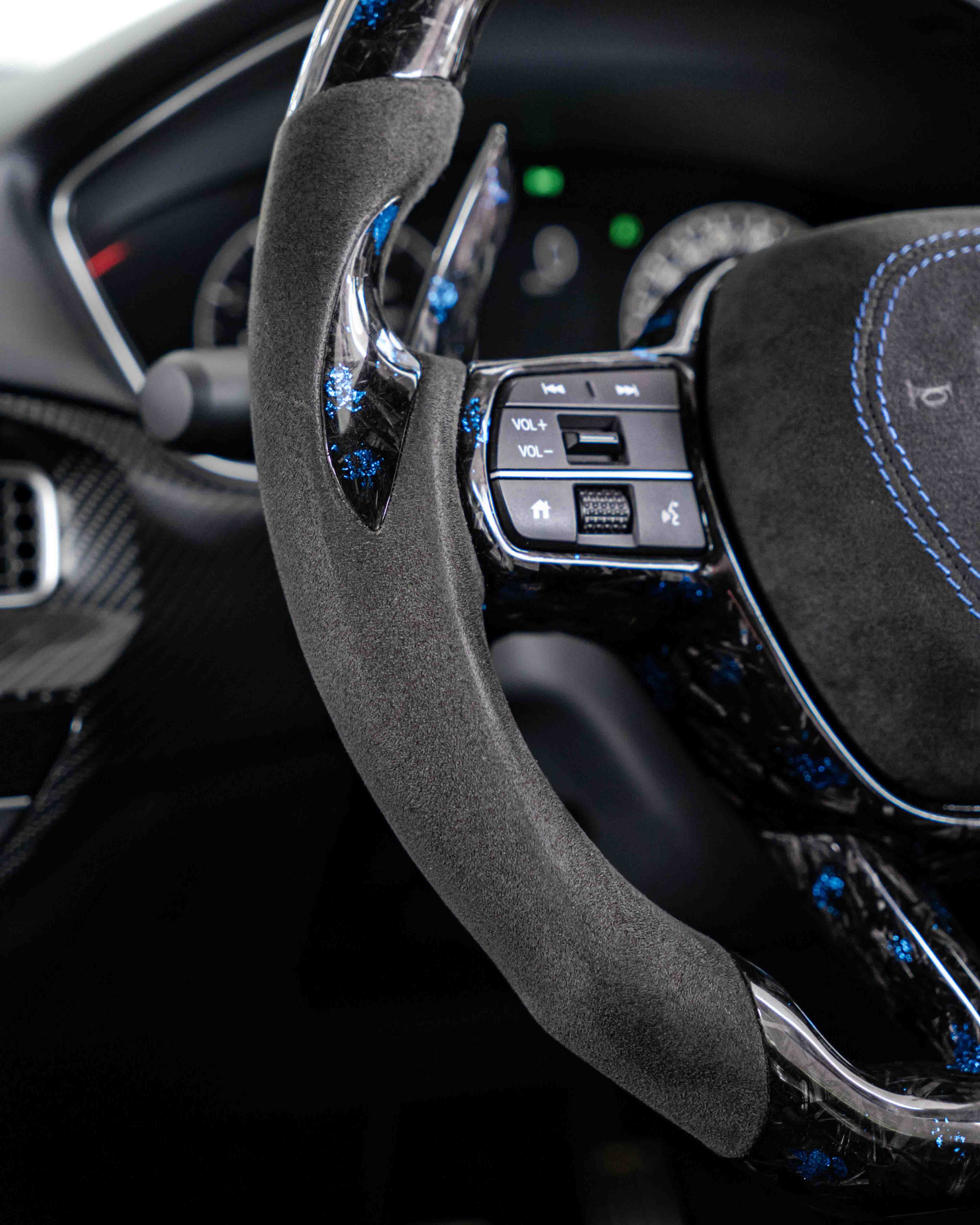 Alcantara side grip on carbon steering wheel.