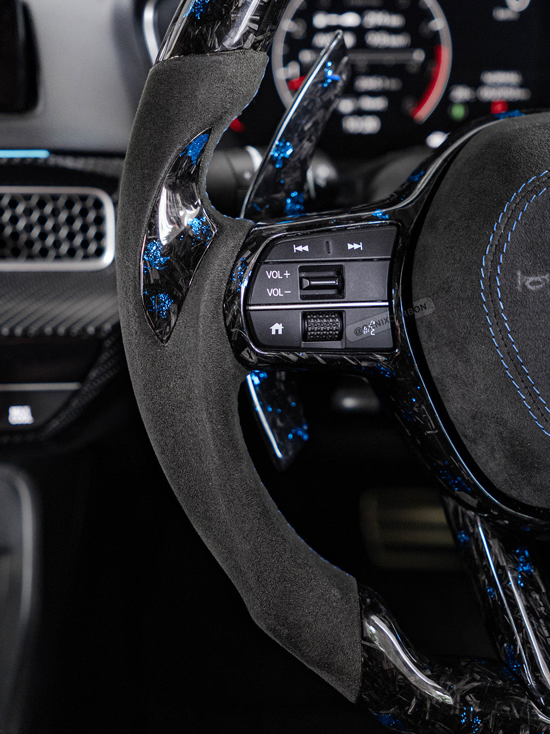 Alcantara side grip on carbon steering wheel.