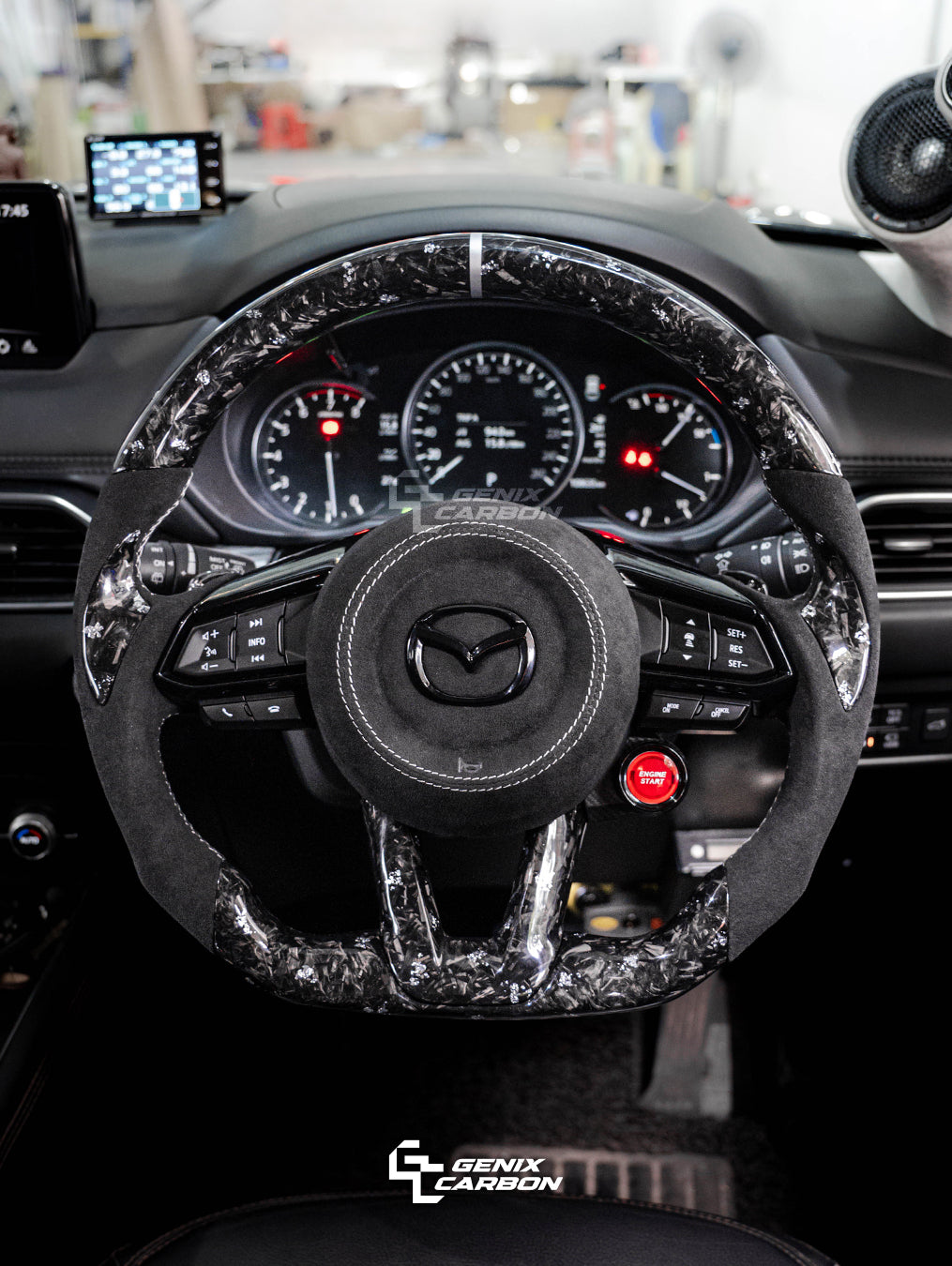 Mazda customizable carbon fiber steering wheel. Featuring 'Genix Carbon' branding.