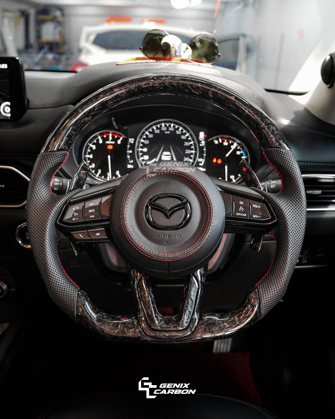 Mazda customizable forged carbon fiber steering wheel. Featuring 'Genix Carbon' branding.