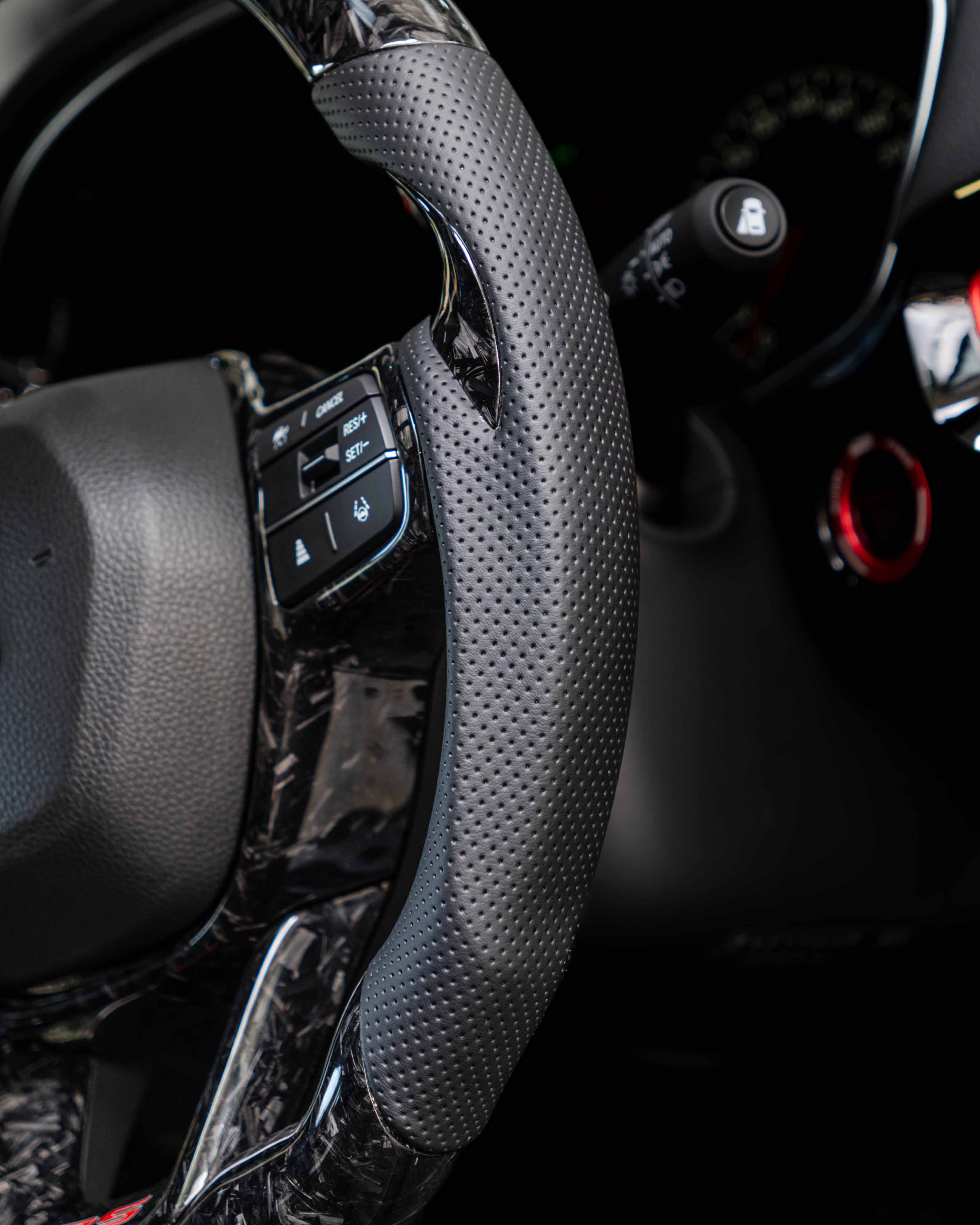Nappa leather side grip on carbon steering wheel.